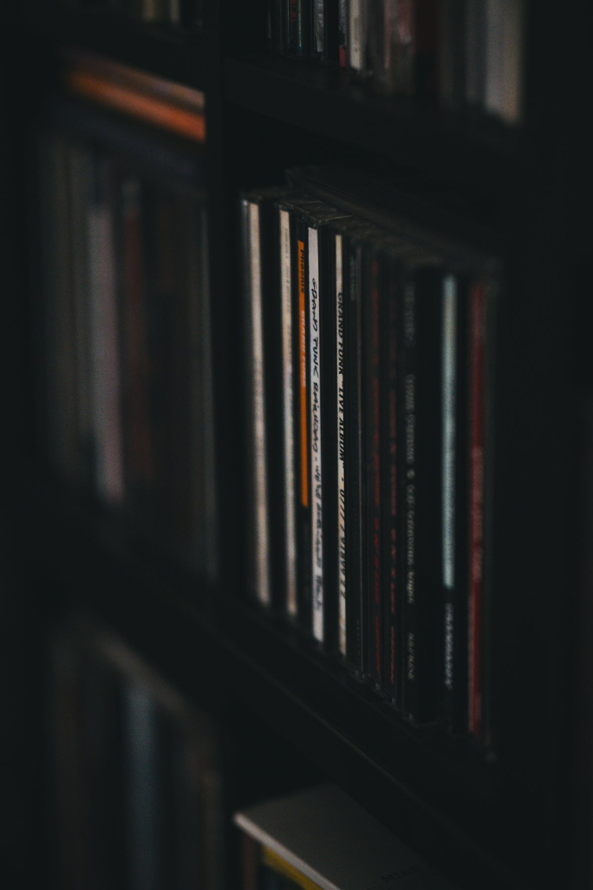 A bookshelf filled with lots of books in a dark room