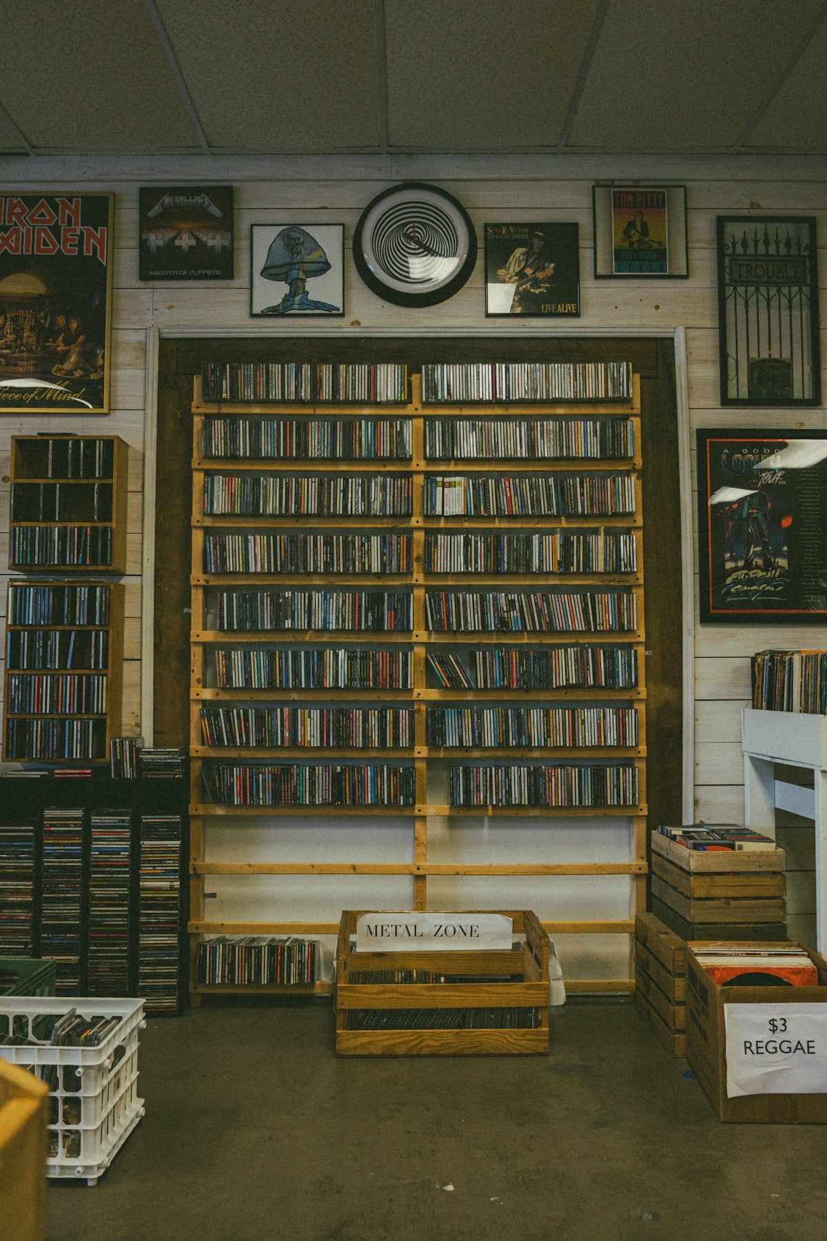 A music store with rows of cds and artwork.